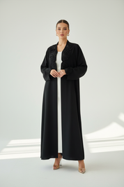 Arab model in black floral abaya