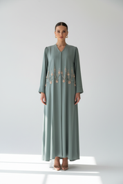 Arab model in sage green beaded floral abaya