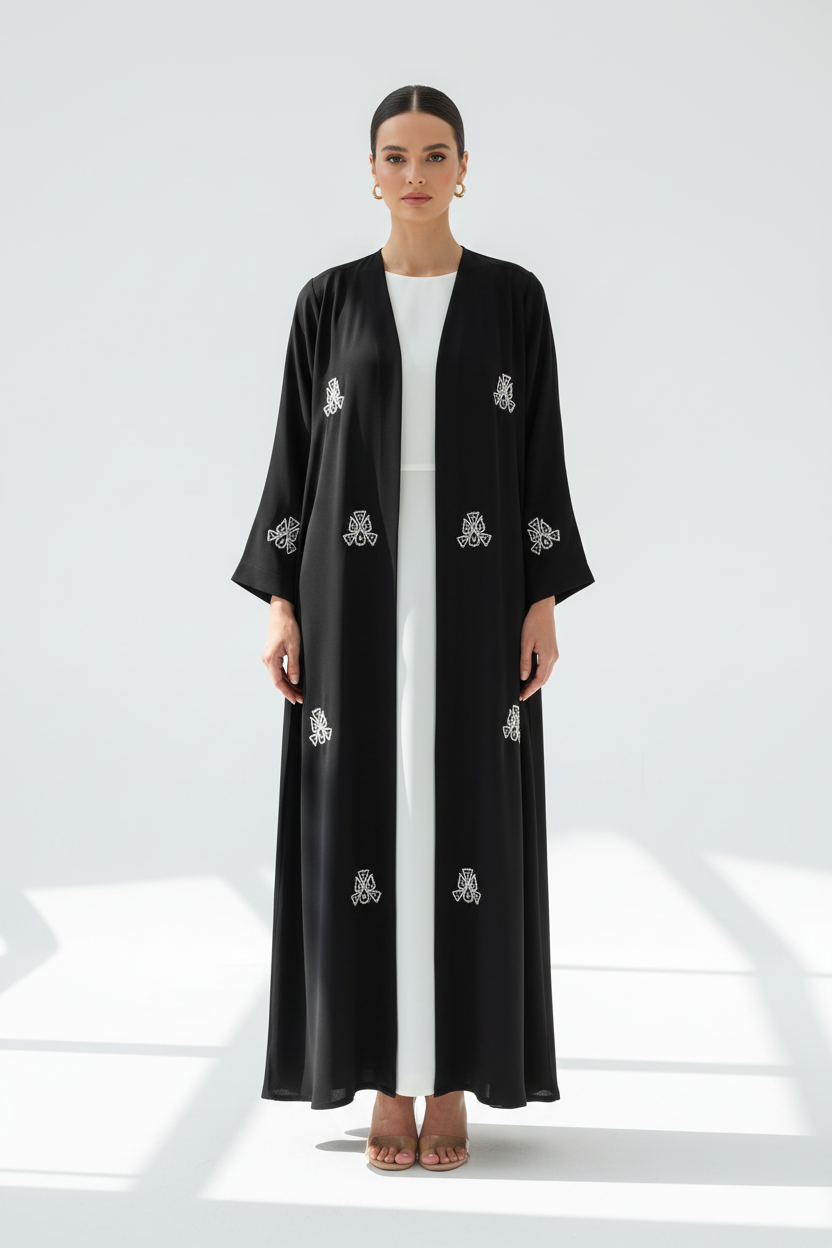 Arab model wearing black abaya with white embroidery - Image 1