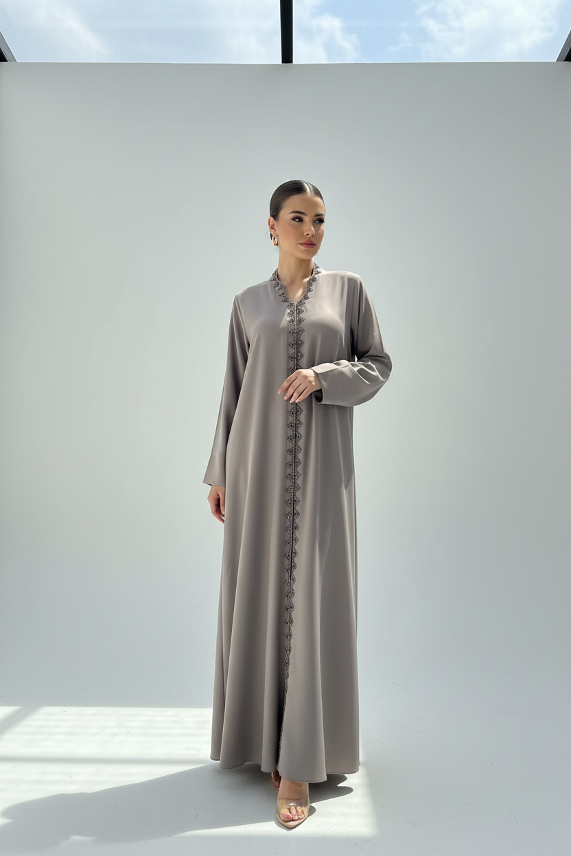 Arab model wearing taupe abaya with silver beading