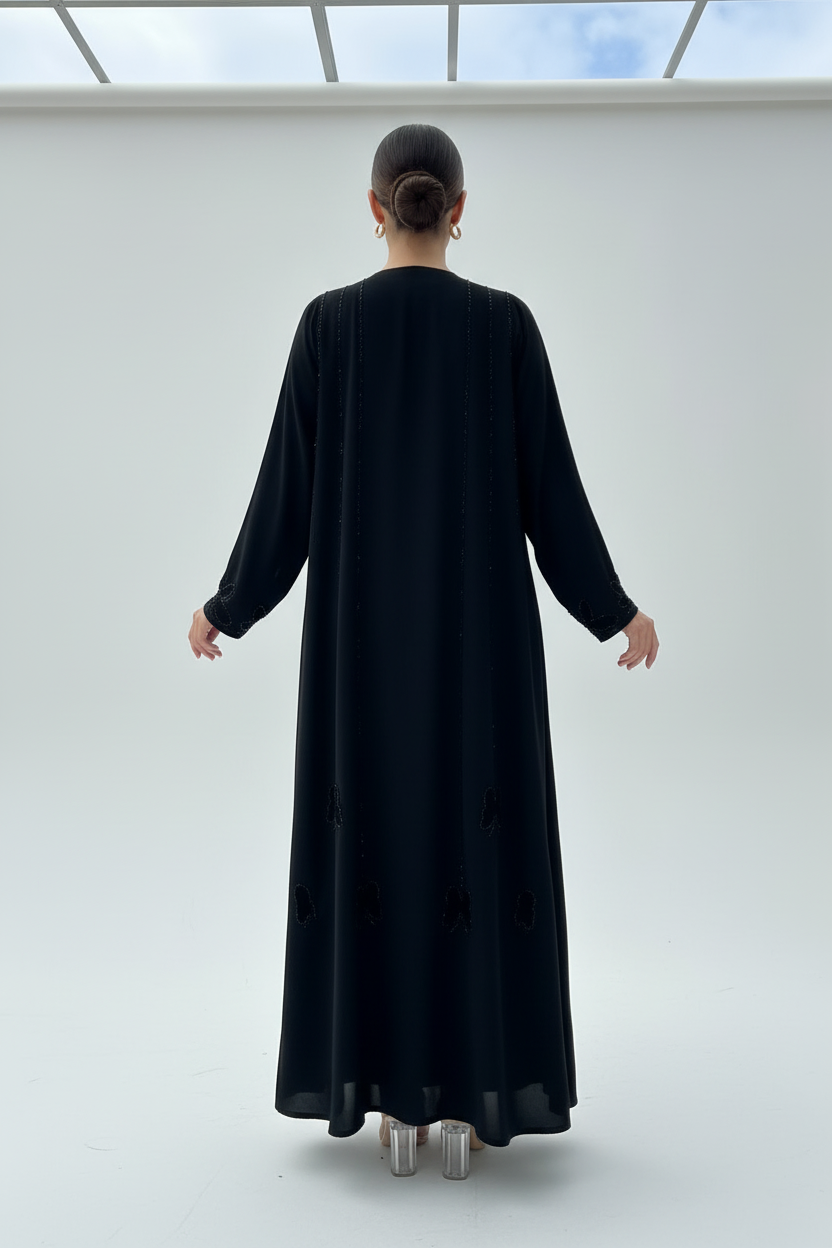 Back view of model in black beaded abaya