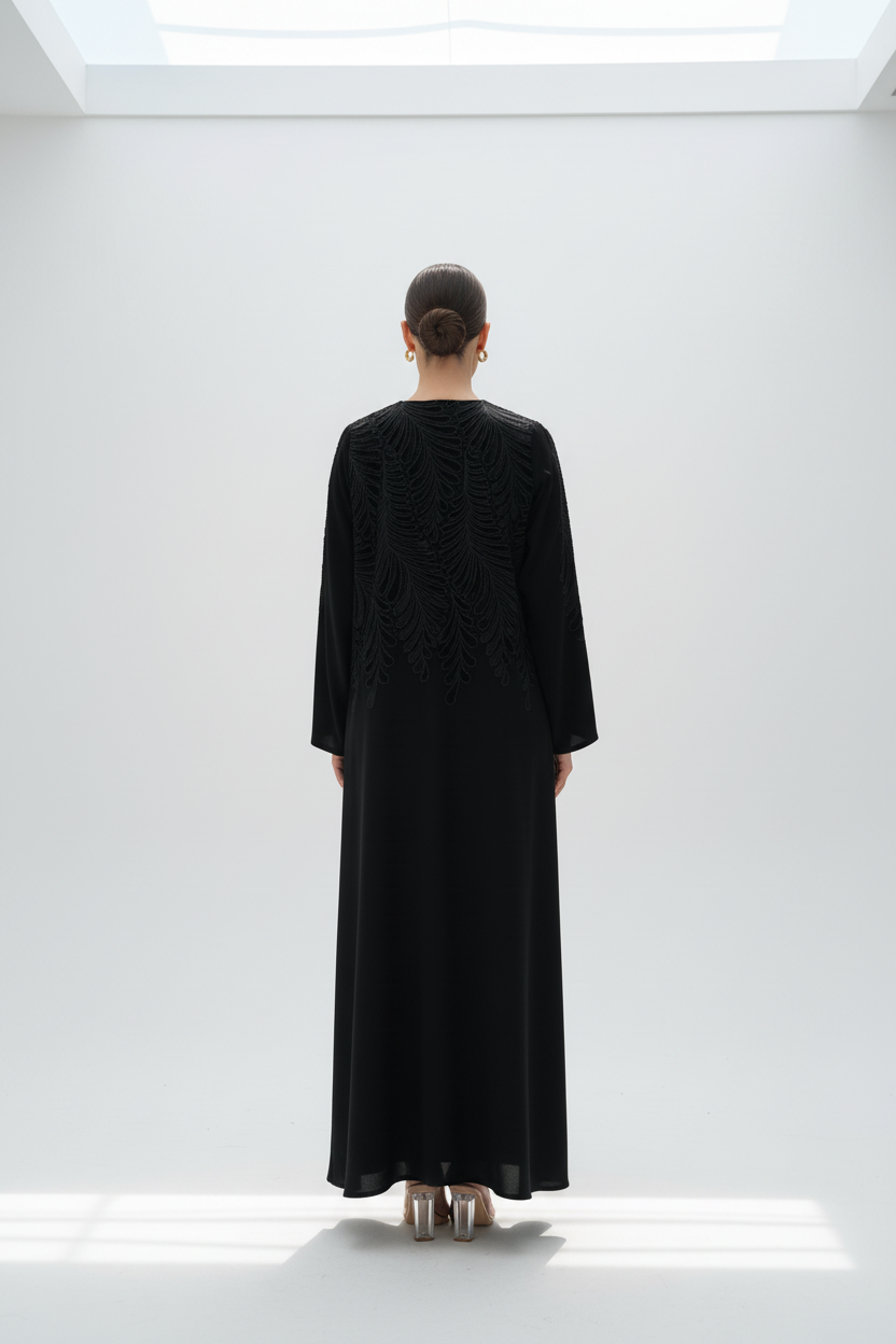 Back view of model in feather-embroidered abaya