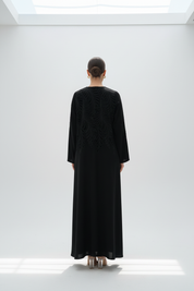 Back view of model in feather-embroidered abaya