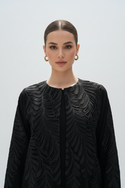 Close-up of model in feather-embroidered abaya