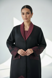 Front-facing portrait with hands clasped gently in front