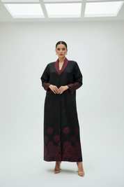 Full body burgundy abaya with hands clasped in front