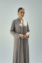 Waist-up shot of Arab model in taupe abaya